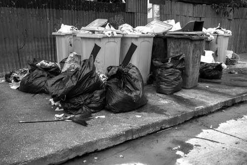 Commercial waste crew outside a Wimbledon shop with a van ready to load