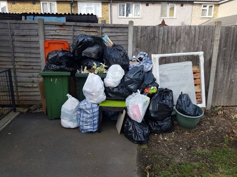 People organizing and clearing items in a flat